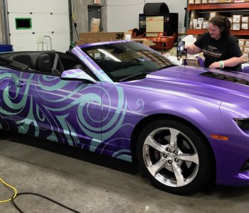 Brand Ink applying heat to set a vehicle wrap